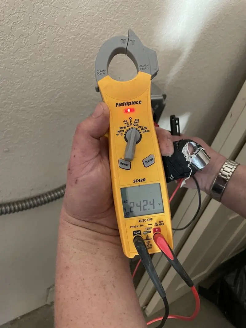 Voltage testing with clamp meter during Ceiling Fan Installation in Tinton Falls